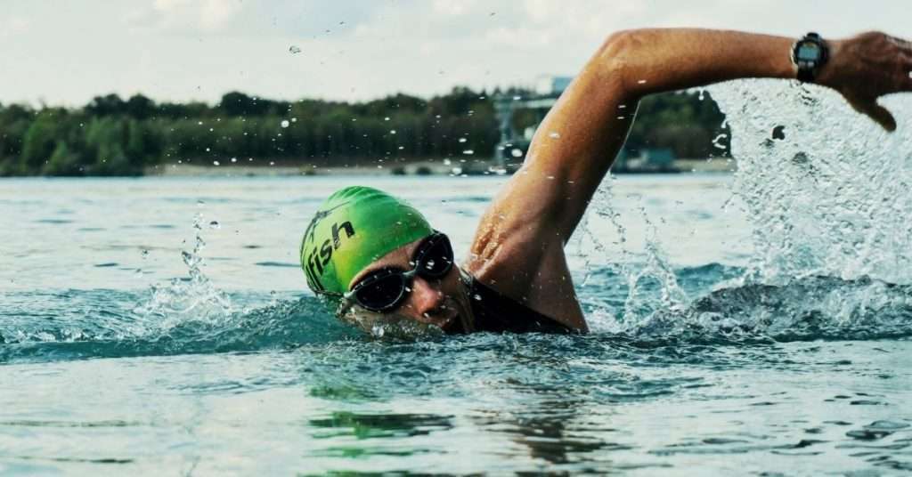 man swimming overhand stroke
